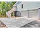 Charming coastal home with a two-car garage, staircase entry, and an expansive concrete driveway at 18 Tupelo Trl, Edisto Island, SC 29438