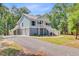Inviting exterior of a raised beach house, with a two car garage at 18 Tupelo Trl, Edisto Island, SC 29438
