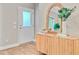 Stylishly decorated foyer with a charming accent cabinet and front door at 18 Tupelo Trl, Edisto Island, SC 29438