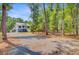 Charming two-story home featuring a well-maintained driveway surrounded by mature trees at 18 Tupelo Trl, Edisto Island, SC 29438