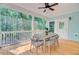 Relaxing screened porch with dining table and seating, offering serene views of the surrounding trees at 18 Tupelo Trl, Edisto Island, SC 29438