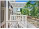 View of outdoor kitchen area with a grill and covered patio, nestled in a wooded landscape at 18 Tupelo Trl, Edisto Island, SC 29438