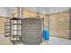 Spacious storage area featuring a large black water tank, blue water tanks and wooden slat walls at 18 Tupelo Trl, Edisto Island, SC 29438