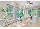 Bright sunroom with walls of windows, stylish decor, and comfortable seating area at 18 Tupelo Trl, Edisto Island, SC 29438
