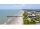 Expansive aerial view showcasing a beautiful beach, pier, and coastal community on a sunny day at 2011 N Highway 17 # 1400A, Mount Pleasant, SC 29466