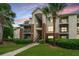 Apartment building featuring exterior stairs, a landscaped lawn, and mature trees at 2011 N Highway 17 # 1400A, Mount Pleasant, SC 29466