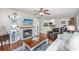 Bright living room featuring a fireplace, hardwood floors, and a ceiling fan at 2011 N Highway 17 # 1400A, Mount Pleasant, SC 29466