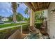 Relaxing screened porch with seating and views of mature trees and the parking area at 2011 N Highway 17 # 1400A, Mount Pleasant, SC 29466