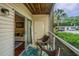 Cozy screened porch with seating and access to the interior and exterior at 2011 N Highway 17 # 1400A, Mount Pleasant, SC 29466