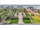 Aerial view of a beautiful beach home with a grand driveway and meticulously manicured landscaping at 210 Ocean Blvd, Isle of Palms, SC 29451