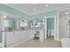 Spacious bathroom with white cabinets, double sinks, and a walk-in shower at 210 Ocean Blvd, Isle of Palms, SC 29451
