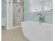 Modern bathroom with a freestanding tub and walk-in shower at 210 Ocean Blvd, Isle of Palms, SC 29451