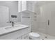 Modern bathroom featuring a white vanity, marble countertop, and a glass-enclosed shower at 210 Ocean Blvd, Isle of Palms, SC 29451