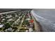 An aerial view of beachfront homes located on the shoreline with ocean views and a nearby road at 210 Ocean Blvd, Isle of Palms, SC 29451