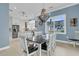 Dining room with view, a striking chandelier, and seating for six at 210 Ocean Blvd, Isle of Palms, SC 29451