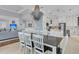 Elegant dining area with modern lighting and views into the kitchen and living room at 210 Ocean Blvd, Isle of Palms, SC 29451