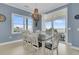 Dining room with an elegant chandelier and sliding glass doors to an outdoor deck with ocean view at 210 Ocean Blvd, Isle of Palms, SC 29451