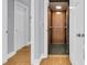 Hallway with an elevator featuring wood paneling and a dark carpeted floor at 210 Ocean Blvd, Isle of Palms, SC 29451