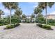 Stunning two-story beachfront home with palm trees and a beautiful brick driveway at 210 Ocean Blvd, Isle of Palms, SC 29451
