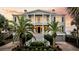 Charming two-story home with a welcoming front porch, set amidst lush tropical landscaping at 210 Ocean Blvd, Isle of Palms, SC 29451