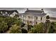 Lovely two-story home with a charming porch overlooking lush foliage and sandy beach at 210 Ocean Blvd, Isle of Palms, SC 29451