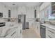 Modern kitchen with stainless steel appliances, island, and elegant countertops at 210 Ocean Blvd, Isle of Palms, SC 29451