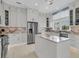 Contemporary kitchen with stainless steel appliances, an island, and sleek white cabinets at 210 Ocean Blvd, Isle of Palms, SC 29451