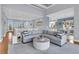 Spacious living room with a large sofa, ocean views, and an open floor plan at 210 Ocean Blvd, Isle of Palms, SC 29451