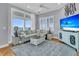 Comfortable living room featuring a large sectional sofa, ocean views, and a wall-mounted TV at 210 Ocean Blvd, Isle of Palms, SC 29451