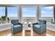 Charming sitting area with ocean views, stylish armchairs, and natural light at 210 Ocean Blvd, Isle of Palms, SC 29451