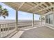 Covered patio overlooking the ocean with white railings at 210 Ocean Blvd, Isle of Palms, SC 29451