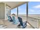 Relaxing porch with chairs facing the ocean view at 210 Ocean Blvd, Isle of Palms, SC 29451