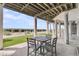 Outdoor patio space under elevated beach house, featuring seating area and ocean view at 210 Ocean Blvd, Isle of Palms, SC 29451