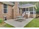 Brick exterior back of home with screened in porch, patio and table at 213 Turtle Point Rd, Summerville, SC 29483