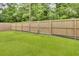 Fenced backyard with lush green grass and a wooden privacy fence at 213 Turtle Point Rd, Summerville, SC 29483
