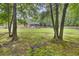 Expansive backyard with lush green grass, mature trees, and a charming screened-in porch at 213 Turtle Point Rd, Summerville, SC 29483
