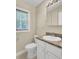 Bright bathroom with a white vanity, granite countertop, and a mirrored medicine cabinet at 213 Turtle Point Rd, Summerville, SC 29483