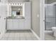 Well-lit bathroom with a granite countertop vanity, a white sink, and a shower at 213 Turtle Point Rd, Summerville, SC 29483