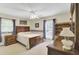Spacious bedroom with a classic wood bed frame, ceiling fan, and natural light from two windows at 213 Turtle Point Rd, Summerville, SC 29483
