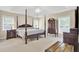 Traditional bedroom with a four-poster bed, matching nightstands, and natural lighting at 213 Turtle Point Rd, Summerville, SC 29483
