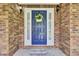 Charming home's entrance with a bright blue door, sidelights, and a welcoming 'Welcome' mat at 213 Turtle Point Rd, Summerville, SC 29483