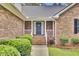 Close-up of the brick home's inviting front porch and blue front door with decorative wreath at 213 Turtle Point Rd, Summerville, SC 29483