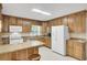 Well-lit kitchen featuring stainless steel appliances, ample counter space, and wood cabinets at 213 Turtle Point Rd, Summerville, SC 29483