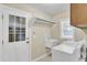 Functional laundry room with a utility sink, white washer and dryer, and a window for natural light at 213 Turtle Point Rd, Summerville, SC 29483