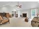 Bright living room featuring a cozy fireplace, vaulted ceiling, and ample seating at 213 Turtle Point Rd, Summerville, SC 29483
