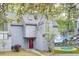 Grey home with a bright red door, an inset of a swimming pool, and mature trees at 2159 Spoleto Ln # E, North Charleston, SC 29406