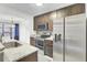 Well-lit kitchen featuring stainless steel appliances, wood cabinetry, and marble countertops at 2159 Spoleto Ln # E, North Charleston, SC 29406