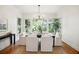 Bright dining room featuring hardwood floors, large windows, and stylish chandelier at 2206 Weepoolow Trl, Charleston, SC 29407
