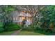 A stately two-story home with double porches surrounded by lush landscaping and mature trees at 2206 Weepoolow Trl, Charleston, SC 29407