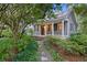 Charming home with a inviting front porch, manicured lawn, and mature trees at 2206 Weepoolow Trl, Charleston, SC 29407